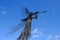 Metal sculpture of a trumpeting angel against the blue sky in Chernobyl. Monument to the