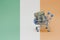 Metal shopping basket with dollar money banknote on the national flag of ireland background. consumer basket concept. 3d