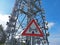 Metal sign with danger of electromagnetic waves. Group of towers for telecommunications, television broadcast, cellphone, radio
