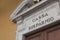 The metal sign of an italian savings bank on a big marble portal