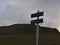 Metal signpost on hiking path near Andenes, AndÃ¸ya island, VesterÃ¥len in northern Norway with mountain peak RÃ¸yken.