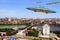 A metal and silver UFO invasion of planet Earth, a group of spaceships fly in the sky above the city and emit yellow rays to the