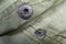 Metal snap button fastener on outerwear closeup in selective focus