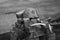 Metal soldiers helmet lying on pile of concrete grey bricks. Soldiers Military Ammunition black and white picture