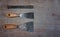 Metal spatula with chisel on wooden worktable