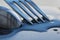 Metal spoon and fork on a large water drop on a clean surface close up