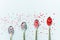  Metal spoons from below with confectionery powder on a white background.