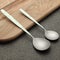 Metal spoons on wood background