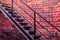 Metal stairway against old brick wall - vivid photo