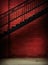 Metal stairway with grunge red brick wall background