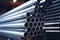 Metal steel pipes cobalt nickel aluminum gray metallic tube stack production line industry pipeline construction site