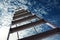 Metal stepladder against sky with clouds, low angle view