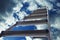 Metal stepladder against sky with clouds, low angle view