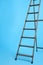 Metal stepladder on blue background. Construction tool