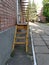 Metal steps painted yellow running to balcony