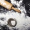 Metal strainer and rolling pin with spilling flour