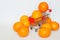 Metal supermarket trolley with ripe orange tangerines. Healthy food. White background