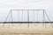 Metal swings on a sandy beach near the ocean