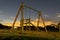 Metal swings on a wooden structure, night photos