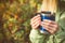 Metal touristic tea cup in Woman hands Outdoor