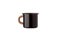 Metal travel mug with thermal insulation on the handle. Convenient unbreakable cup for hot and cold drinks isolate on a white back