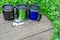 Metal travel mugs black blue green on wooden boards