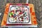 metal tray on a table filled with various candy