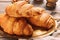 Metal tray with tasty croissants on table