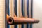 Metal tubular bells with a bamboo tube hang on the wall and create the music of the wind