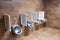 Metal urinals and one for children with an automatic sensor for flushing water after urinating. Men`s toilet in brown marble