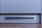 Metal ventilation grill in a gray cabinet