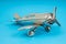 Metal vintage aircraft toy, with front propeller. Retro toy on blue background