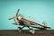 Metal vintage aircraft toy, with front propeller. Retro toy on wooden board