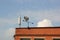 Metal weather vane on the roof of the building