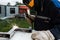 Metal welder working with arc welding machine to weld steel while wearing safety equipment