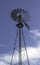 Metal Windmill Against Blue Sky and White Clouds