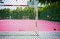 Metal wire fence or wire mesh green steel with blur football or pink Futsal Sports Flooring background