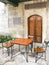 Metal and wooden table with two Arabic style chairs in front of