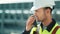 Metal worker in uniform and hard hat with walkie talkie medium close-up