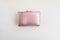 Metalized pink pastel female wallet on a white background flat layout view reconciliation. Business, finance, money