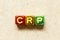 Metallic alphabet letter block in word CRP abbreviation of C-Reactive Protein Test on wood background