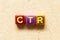 Metallic alphabet letter block in word CTR Abbreviation of Click trough rate on wood background