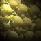 Metallic balls with golden glitter on a light brown wavy gradient background.