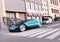 Metallic blue self driving sedan driving on the street