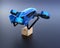 Metallic blue VTOL drone carrying delivery packages takeoff from black background