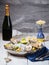 Metallic bowl with fresh appetizing oysters with ice and lemon