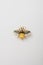 Metallic brooch in shape of bee with gemstones imitation, pin on white background, bijouterie, jewelry close up