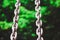 Metallic chains in clear silver color and blurred background of trees