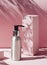 Metallic Cosmetic bottle on the pink background with harsh light. Close up