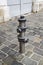 metallic fire hydrant on street with stone paving